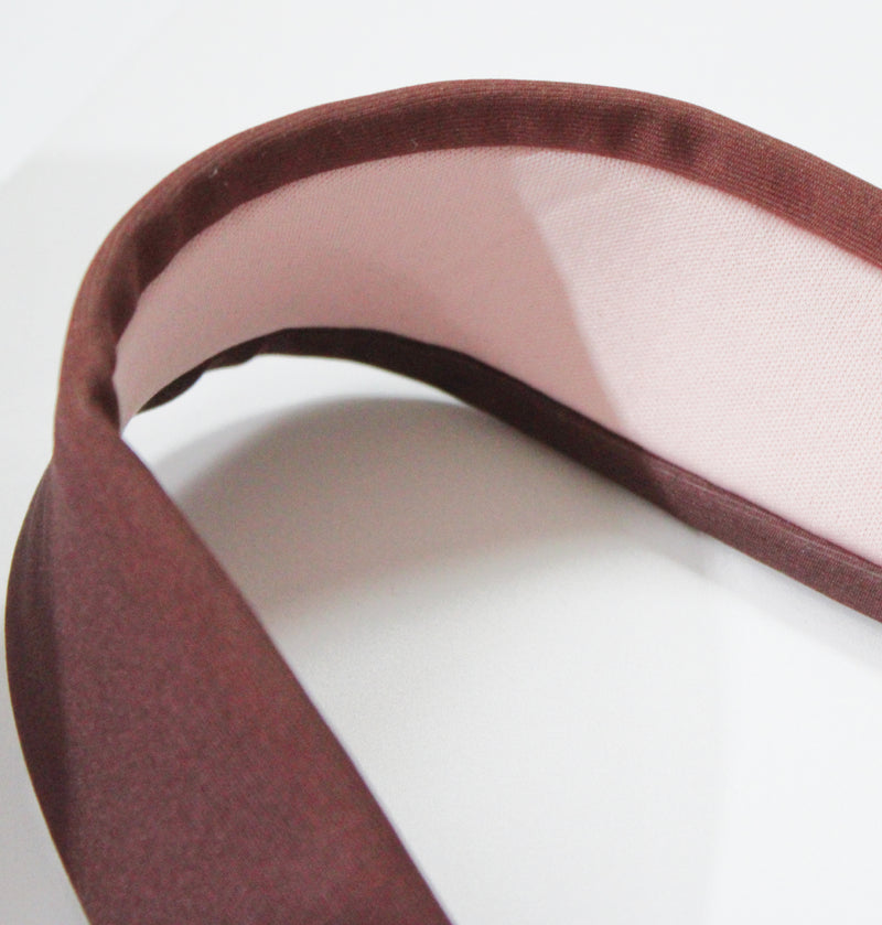 Close-up of the Tigers Eye sports bra’s wide, padded straps in brown and pink, designed for added support and to prevent strap digging.